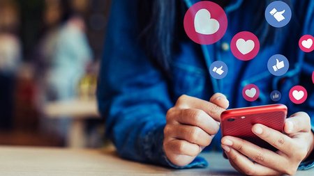 midsection-of-woman-using-smart-phone-on-table-in-royalty-free-image-1580162828